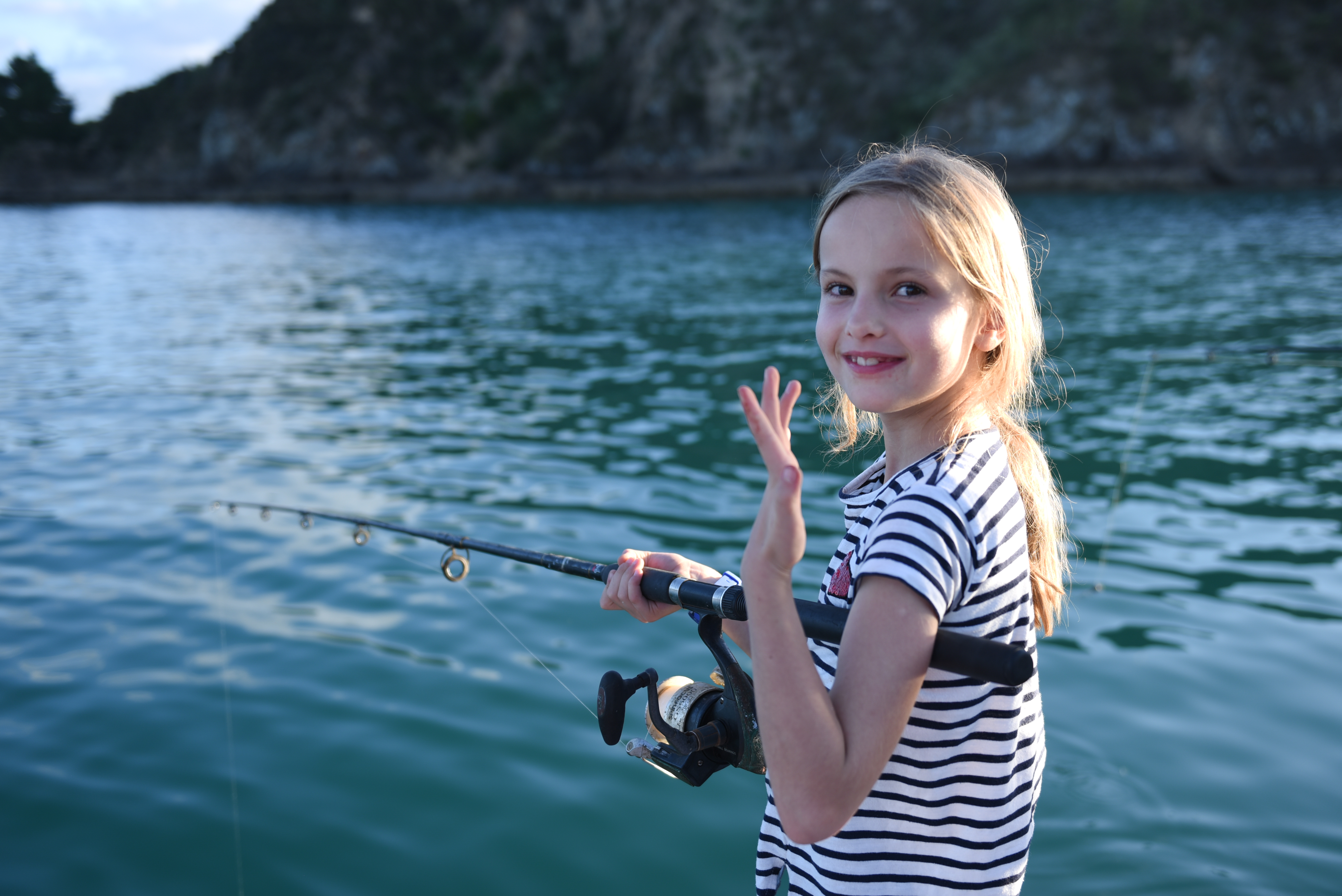 little girl dusk fishing aboard The Rock Adventure Cruise