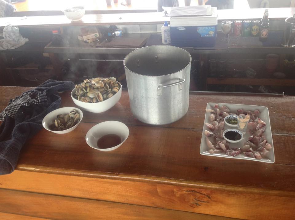 Pot of steamed cockles and sashimi