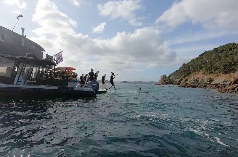 girls ready to snorkel jumping off the rock boat