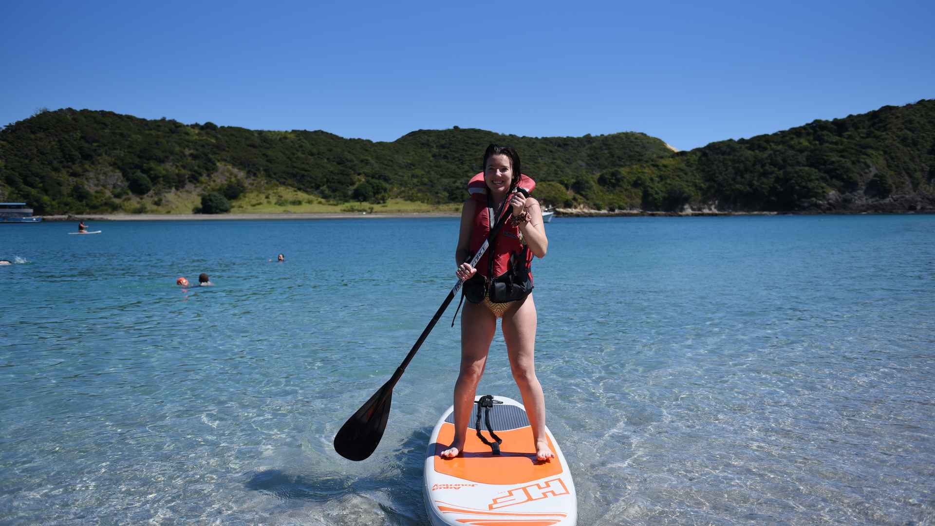Female guest paddle boarding at waewaetorea