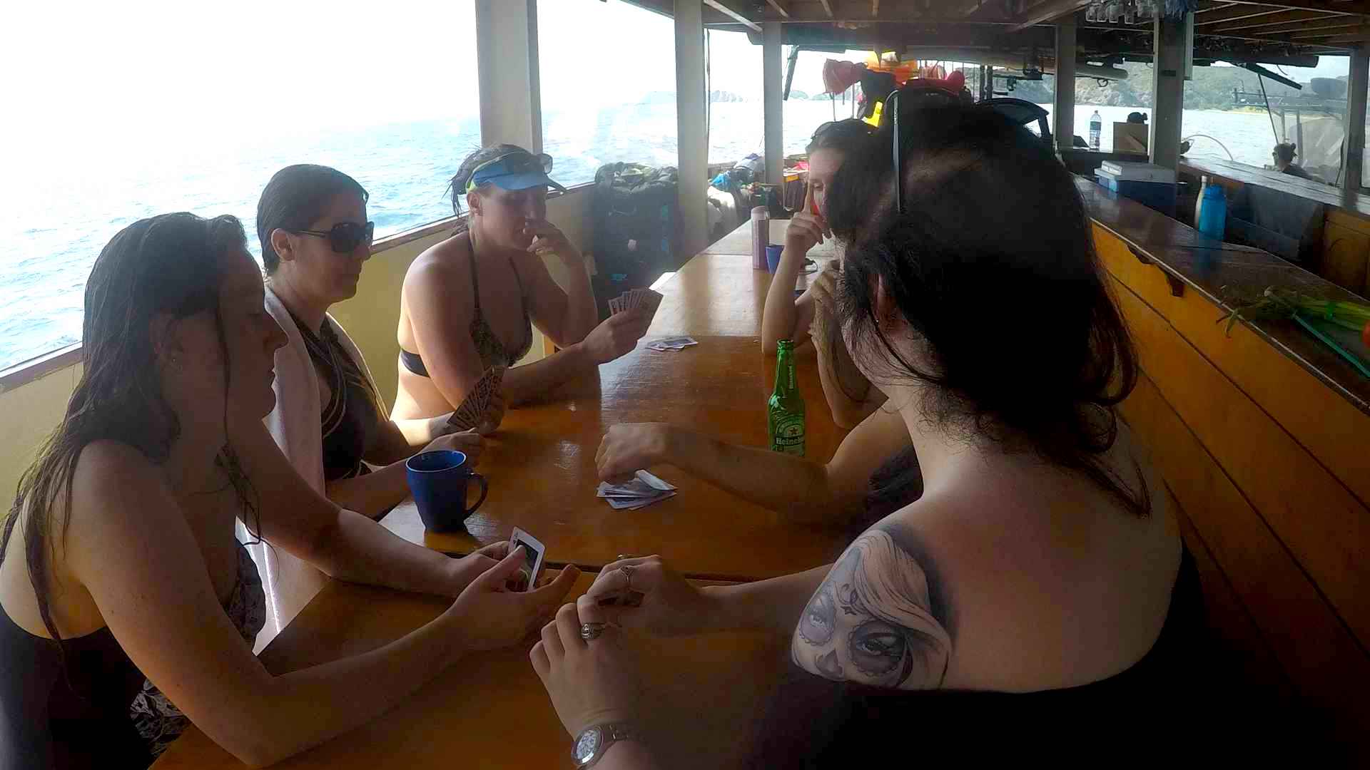 girls playing cards at the rock adventure cruise new zealand