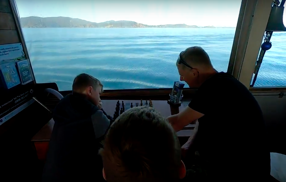 father and son playing chess at The Rock Adventure Cruise