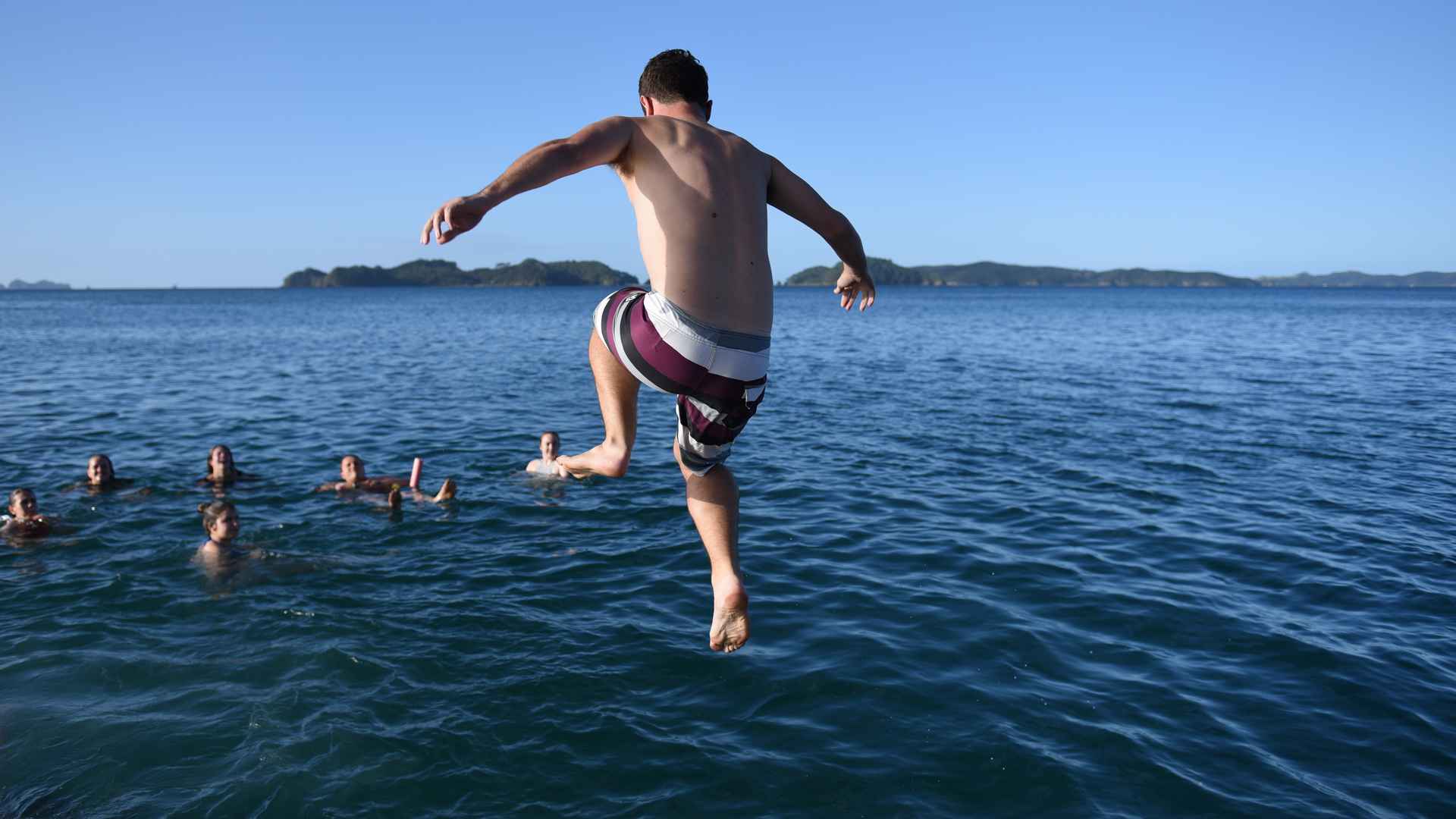 diving from the rock boat into the bay of islands