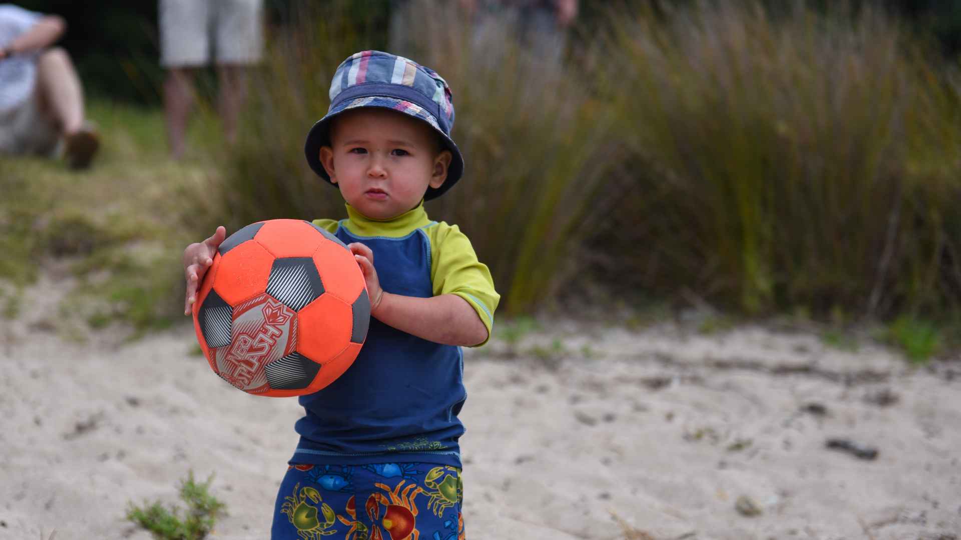 young boy beach play with ball