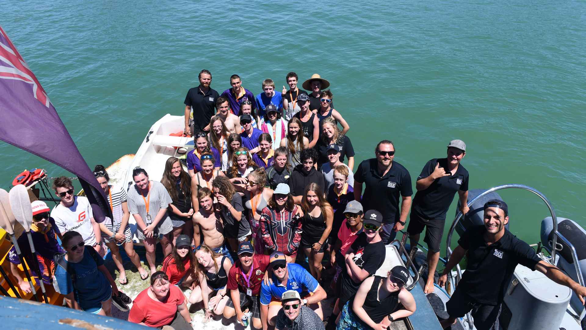 big group pic back of boat the rock