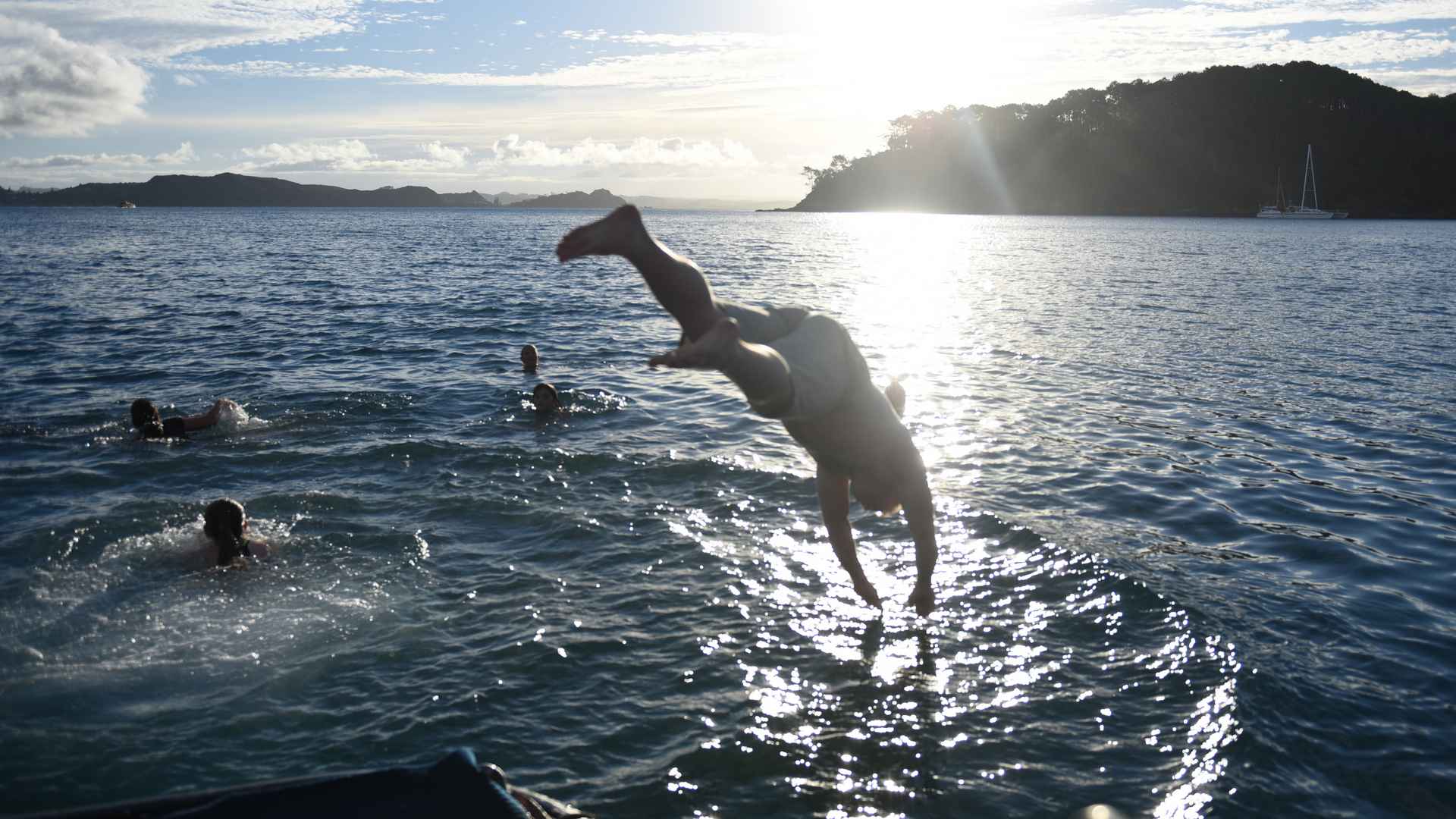 late afternoon guests swimming off the rock