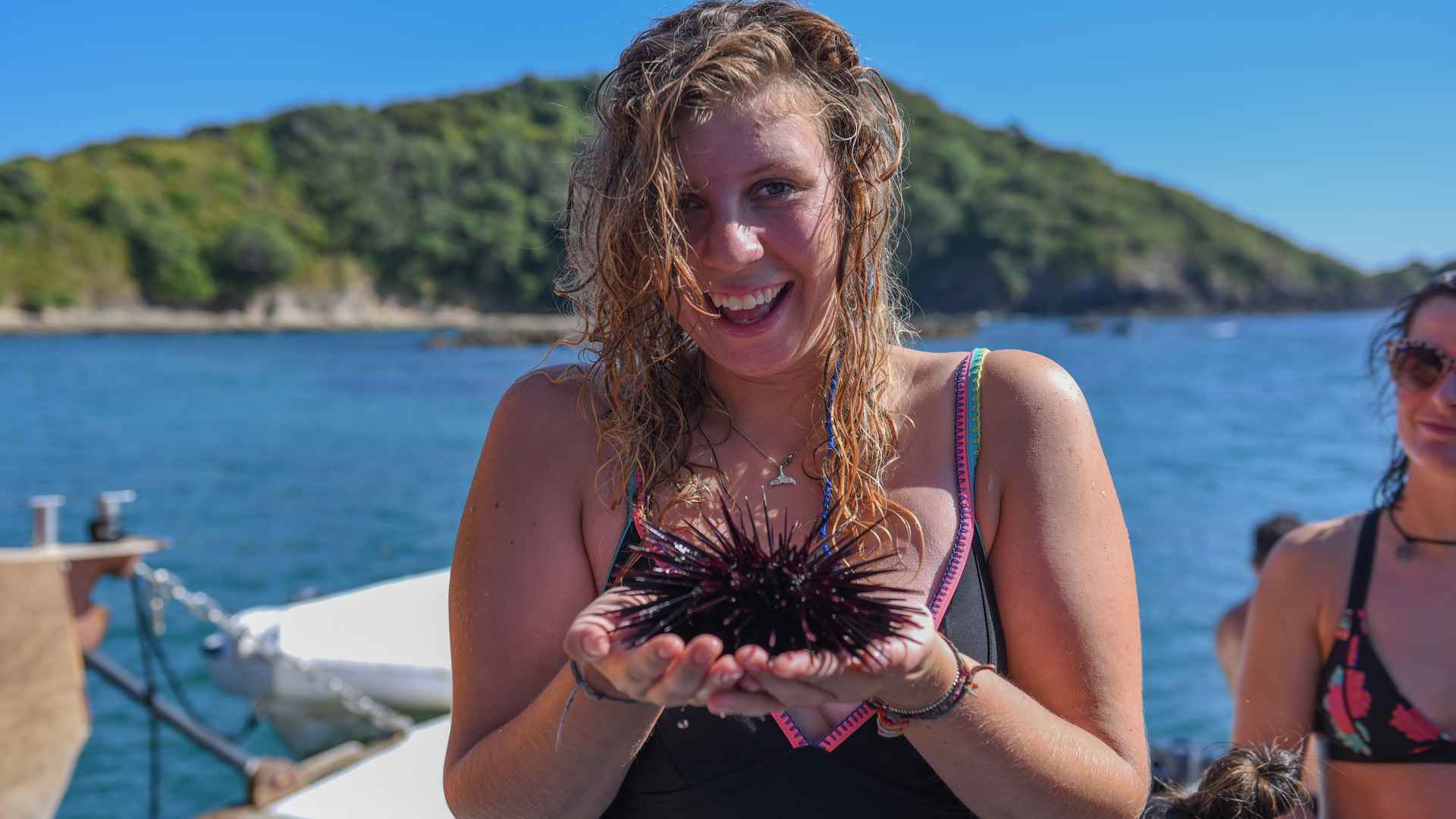 guest holding long spiky sea urchin