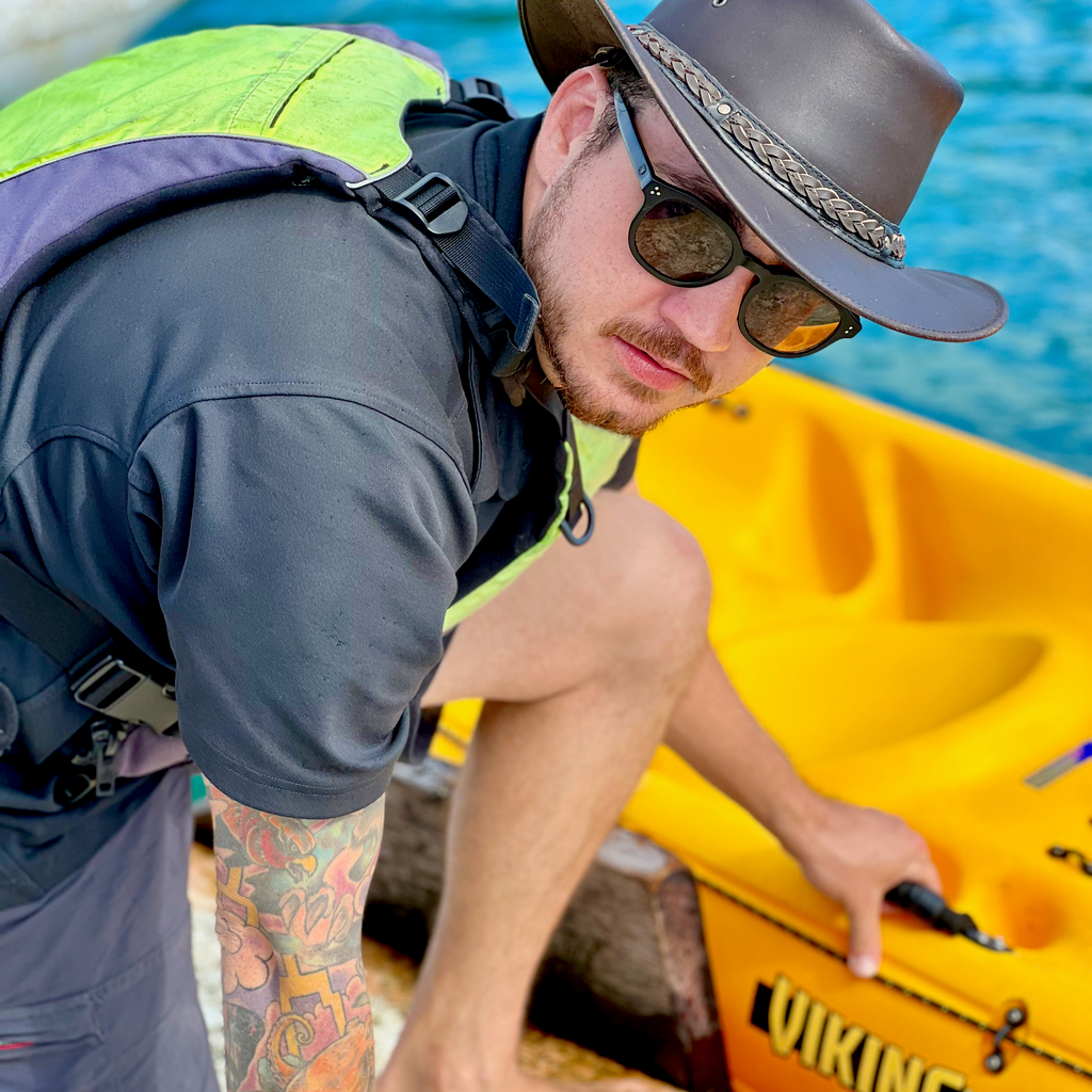 sean preparing kayaks for guest on rocktheboatnz